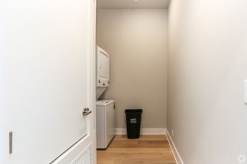 Laundry area with stacked washer and dryer